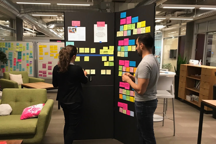 Two people use SHAY boards to make an information radiator